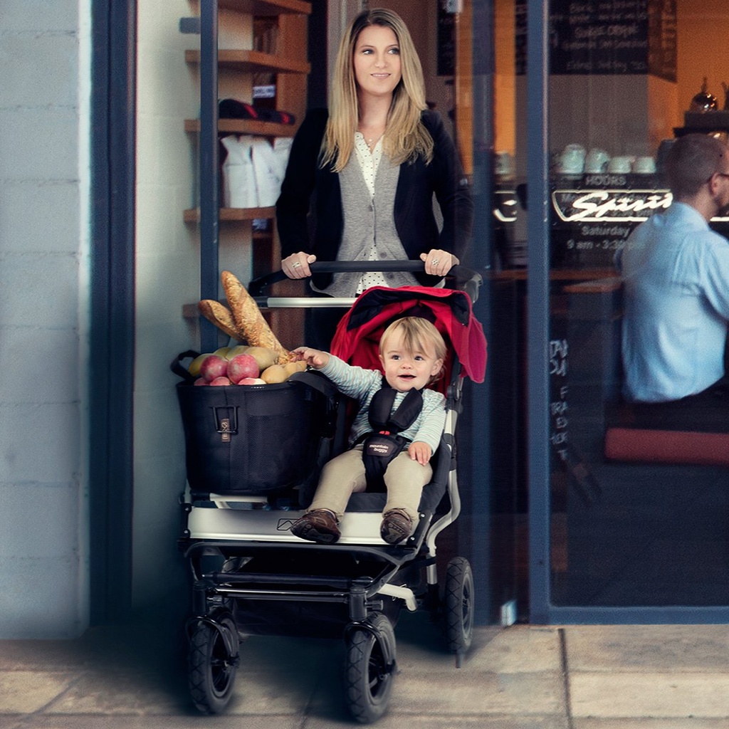 Mum and son walking out of cafe in the duet buggy with joey toe bag full of groceries_default